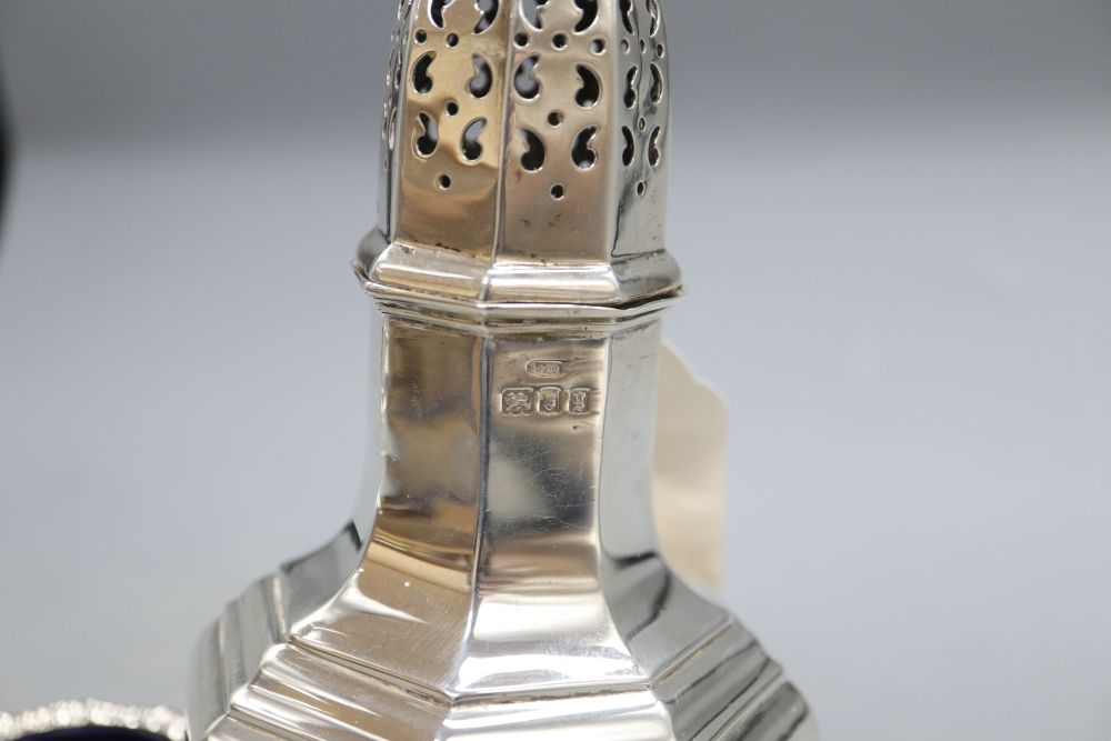 A George V silver sugar caster, London, 1922, 21cm and two silver bun salts, gross 12oz.